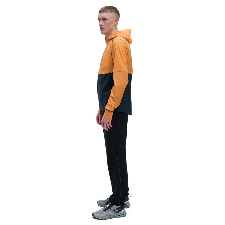 Side model view of men's on weather jacket in orange (7518271242402)