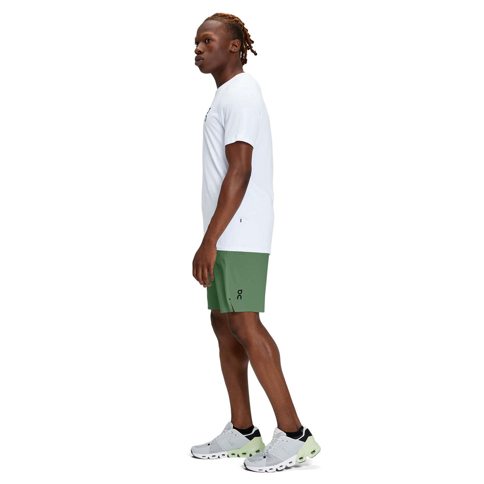 A model wearing a pair of men's On Hybrid Shorts in the ivy colour (7763890536610)