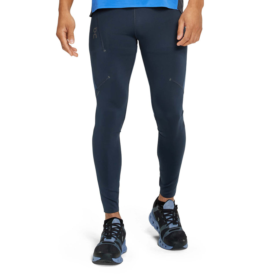 Front view of a model wearing a pair of men's On Performance Tights in the Navy and Denim colour (7763897155746)