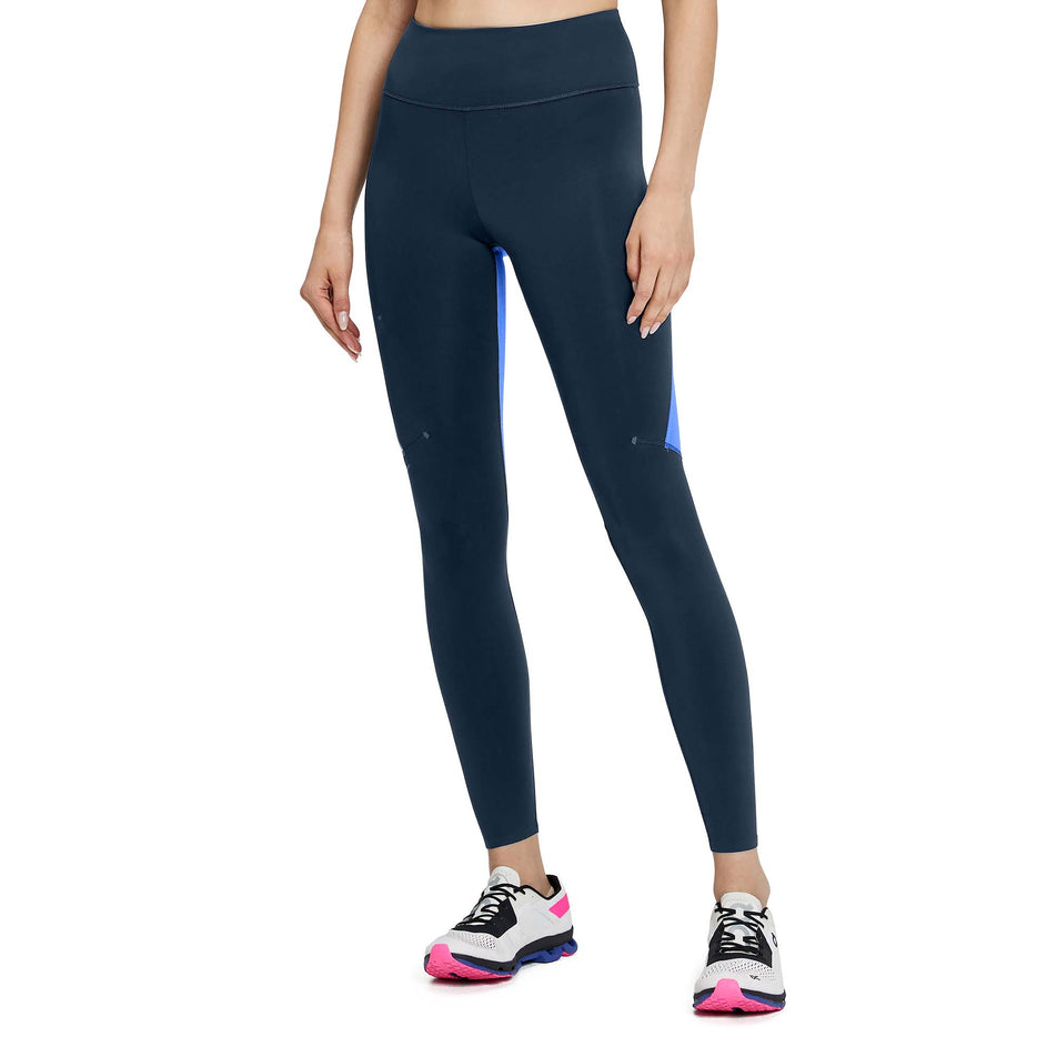 Front view of a model wearing a pair of women's On Performance Tights in the Navy and Cobalt colour (7763911540898)