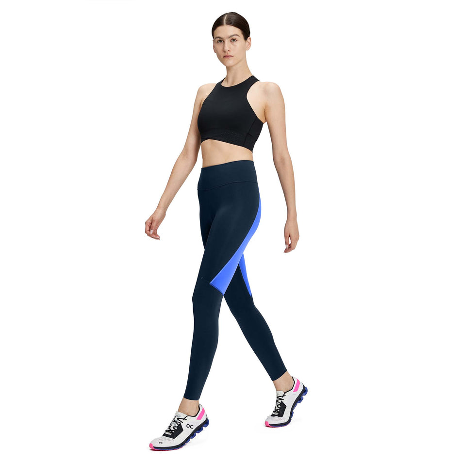 Front view of a model wearing a pair of women's On Performance Tights in the Navy and Cobalt colour (7763911540898)