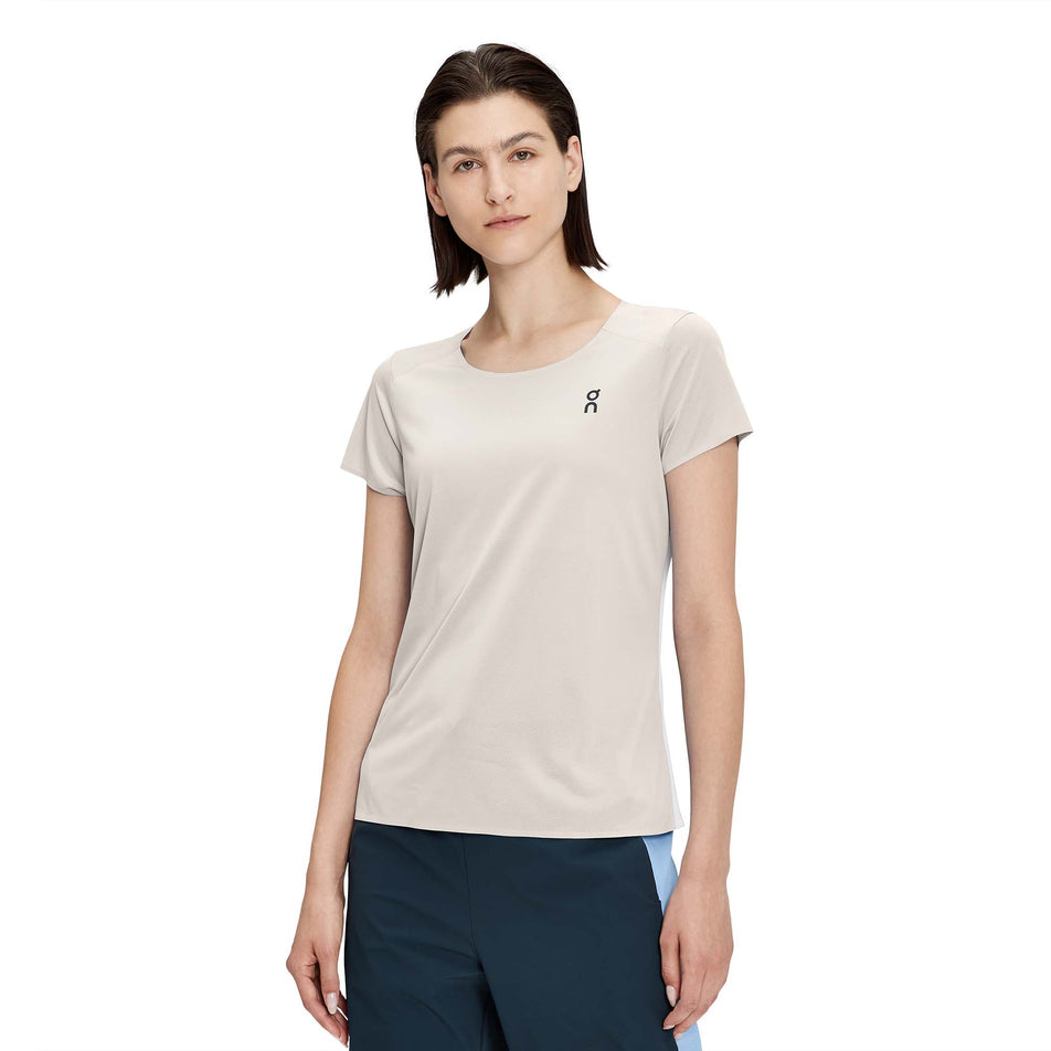 Front view of a model wearing a women's On Performance T in the pearl and undyed white colour (7763908853922)