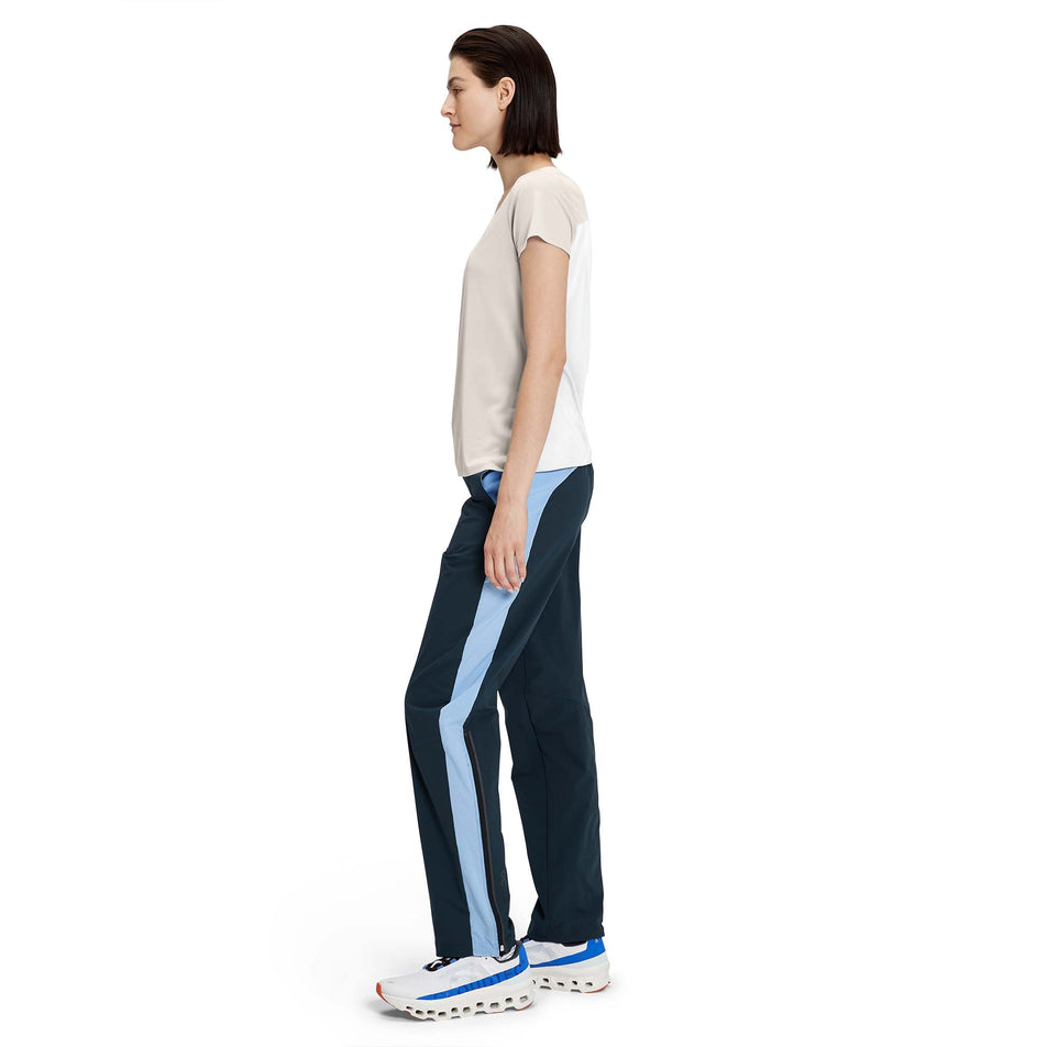 Left-side view of a model wearing a women's On Performance T in the pearl and undyed white colour (7763908853922)