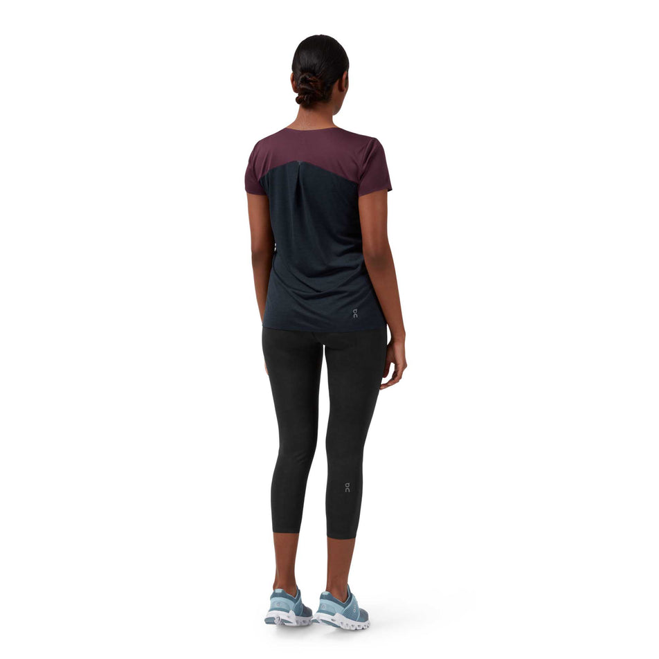 Woman wearing On Performance S/S T-Shirt facing to the back. (6993690558626)