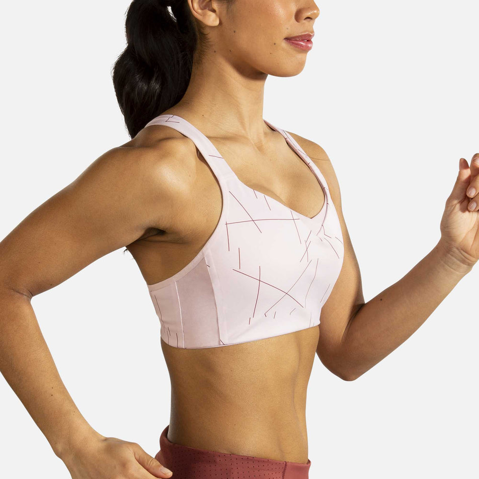 A model wearing the women's Brooks Drive Convertable Run Bra in a running stance  (6935121887394)