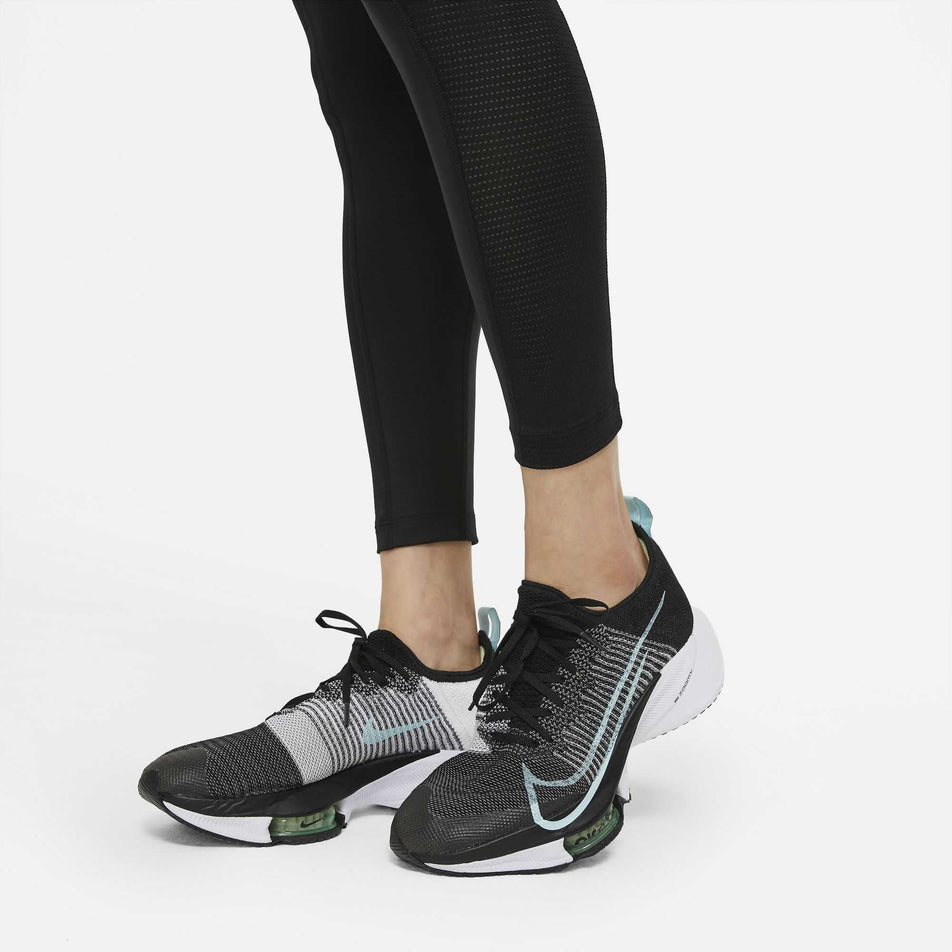The perforated lower detailing on a women's Nike Run Division Epic Fast Tight GX worn by a model (6936939724962)