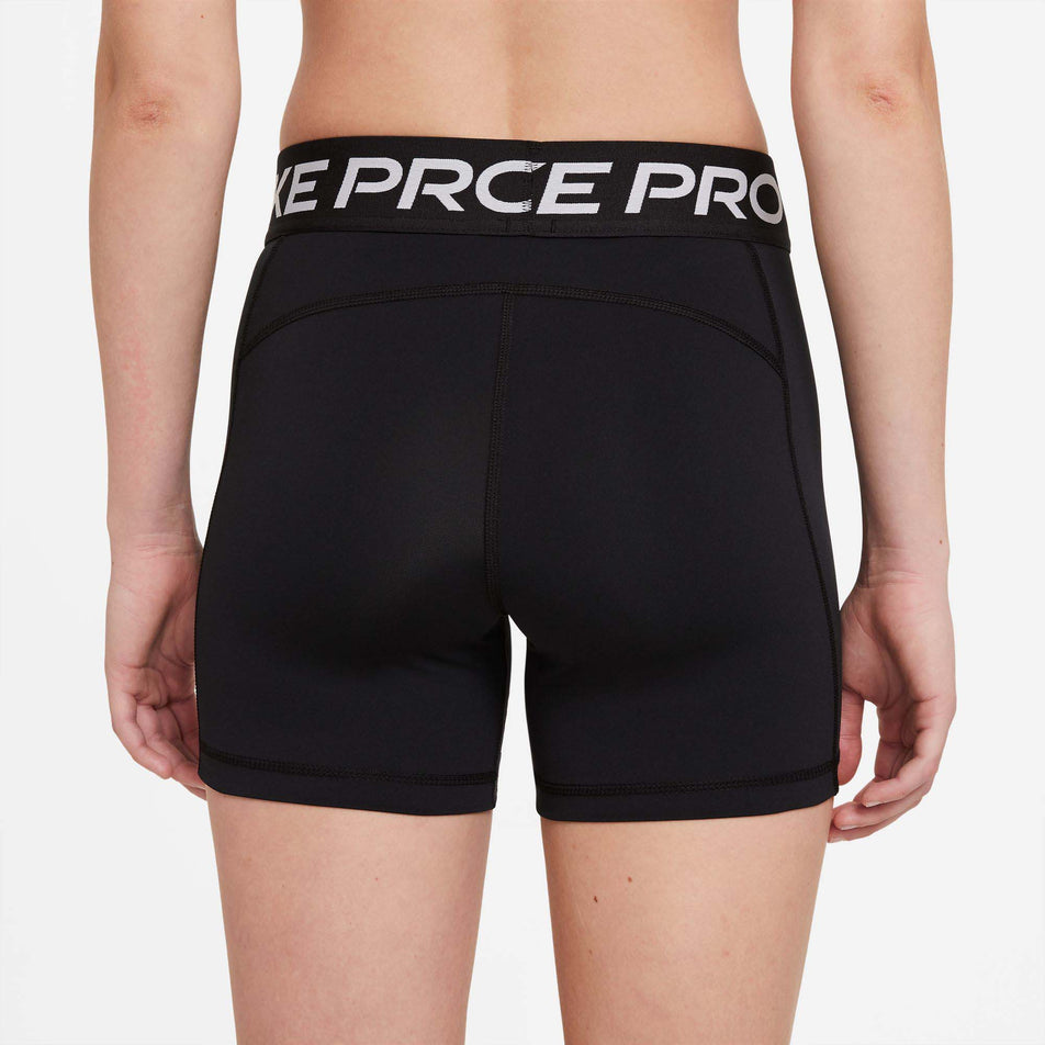 Rear view of Nike Women's NP 365 Short 5 Inch in black. (7729545478306)