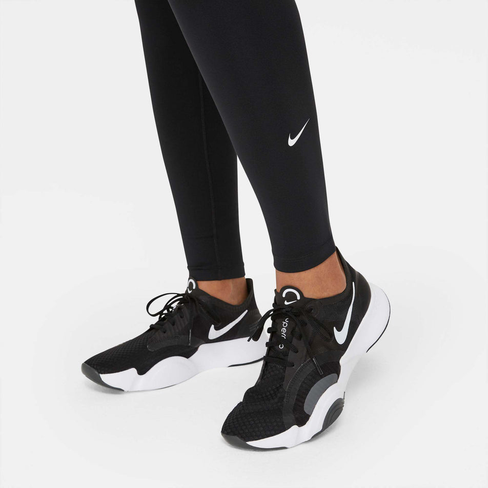 Ankle logo cuff view of Nike Women's One Dri-Fit MR Running Tight Plus in black (7677572382882)