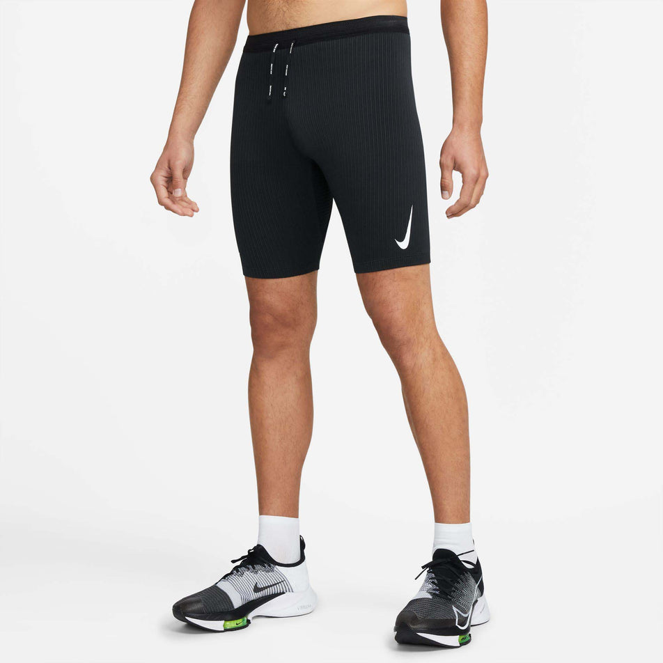 Front view of a model wearing a pair of Nike Men's Dri-FIT ADV AeroSwift 1/2-Length Racing Tights (7876595712162)