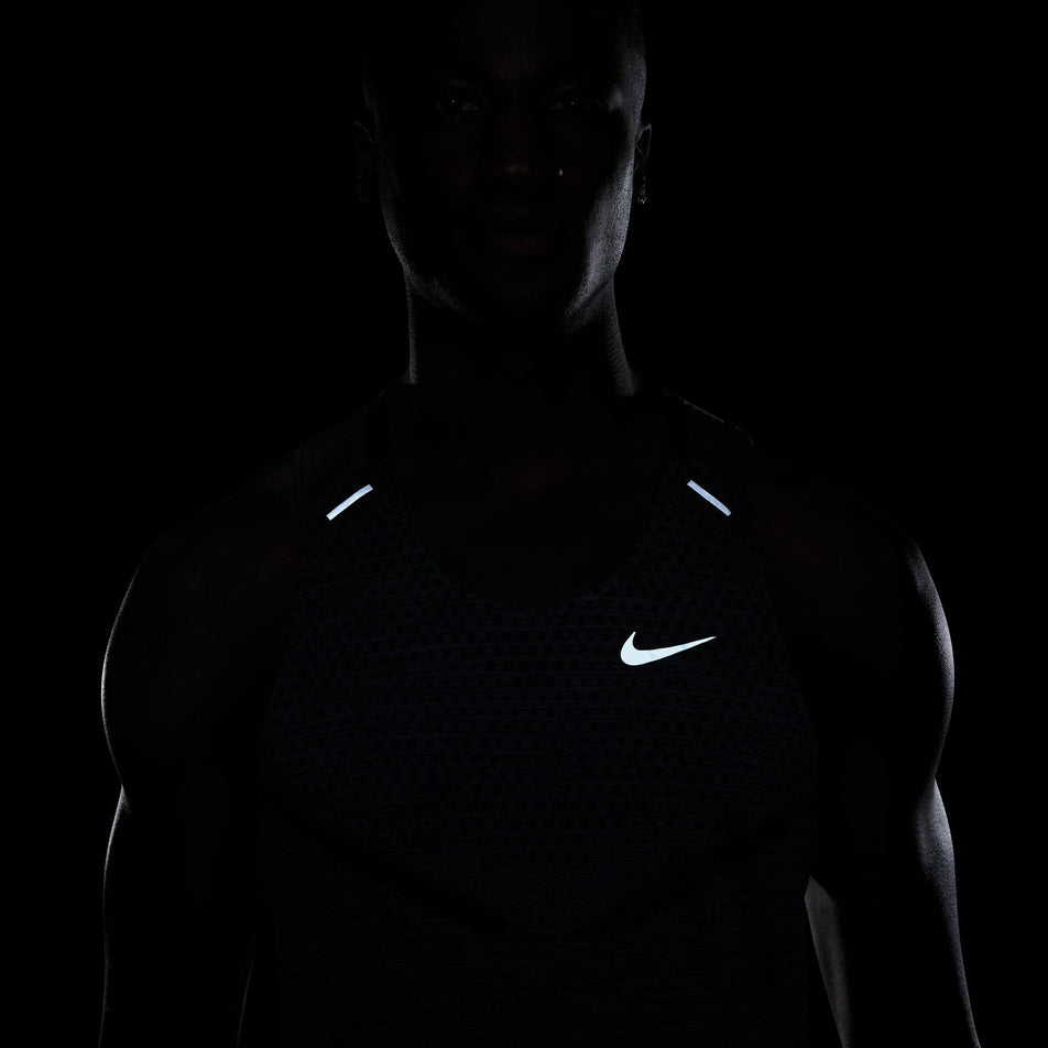 Front view of a model wearing a Nike Men's Dri-FIT ADV Techknit Ultra Running Tank - demonstrating the reflectivity on the front (7876647288994)