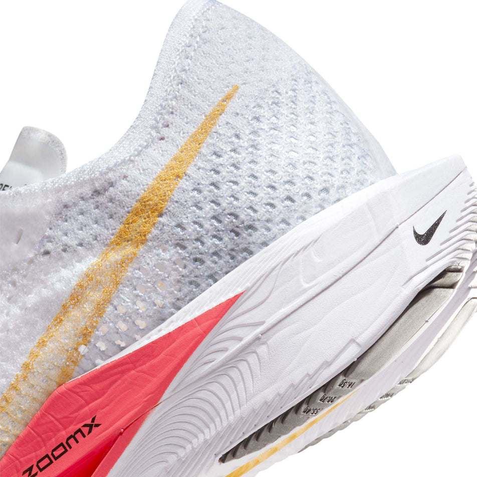 Close-up of the lateral side of the heel counter on the left shoe from a pair of Nike Women's Vaporfly 3 Road Racing Shoes in the White/Topaz Gold-Sea Coral-Pure Platinum colourway (7867372372130)