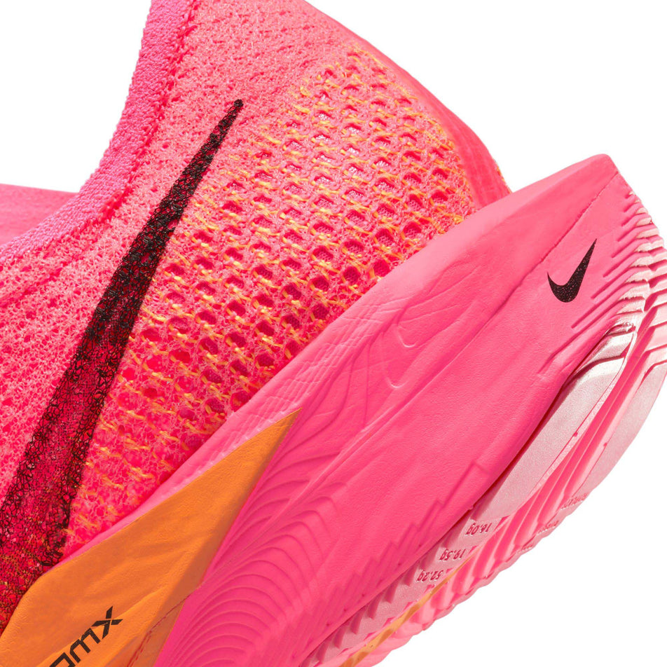 The lateral side of the heel of the left shoe from a pair of Nike Women's Vaporfly 3 Road Racing Shoes in the Hyper Pink/Black-Laser Orange colourway (7867373584546)