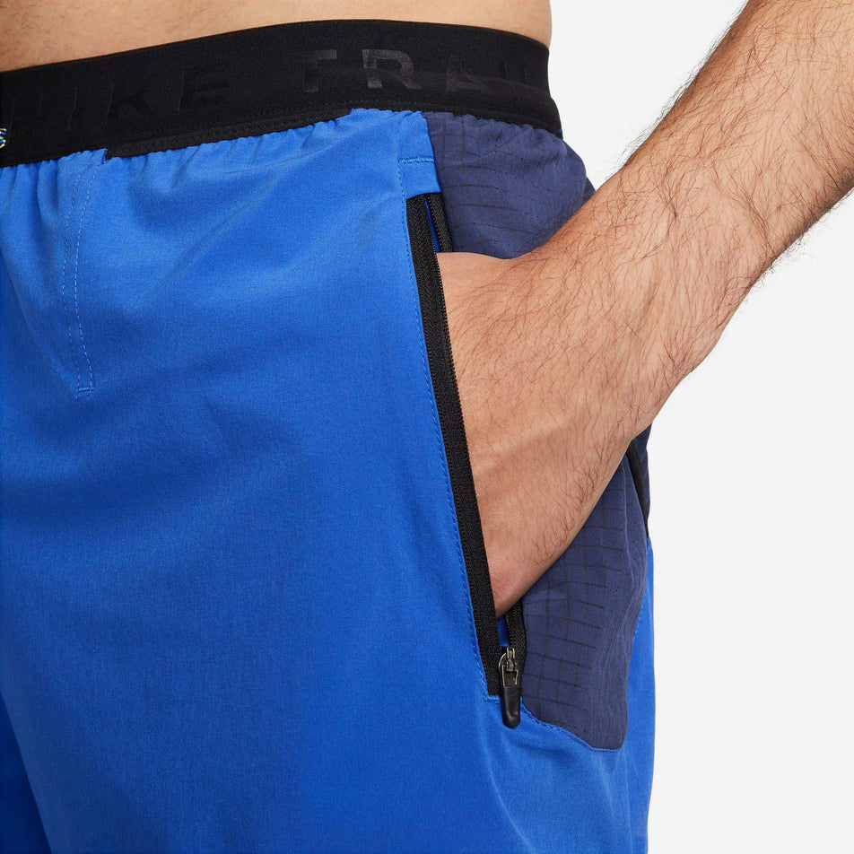 Side pocket view of Nike Men's DF Trail Running Short 5 Inch in blue. (7729616945314)