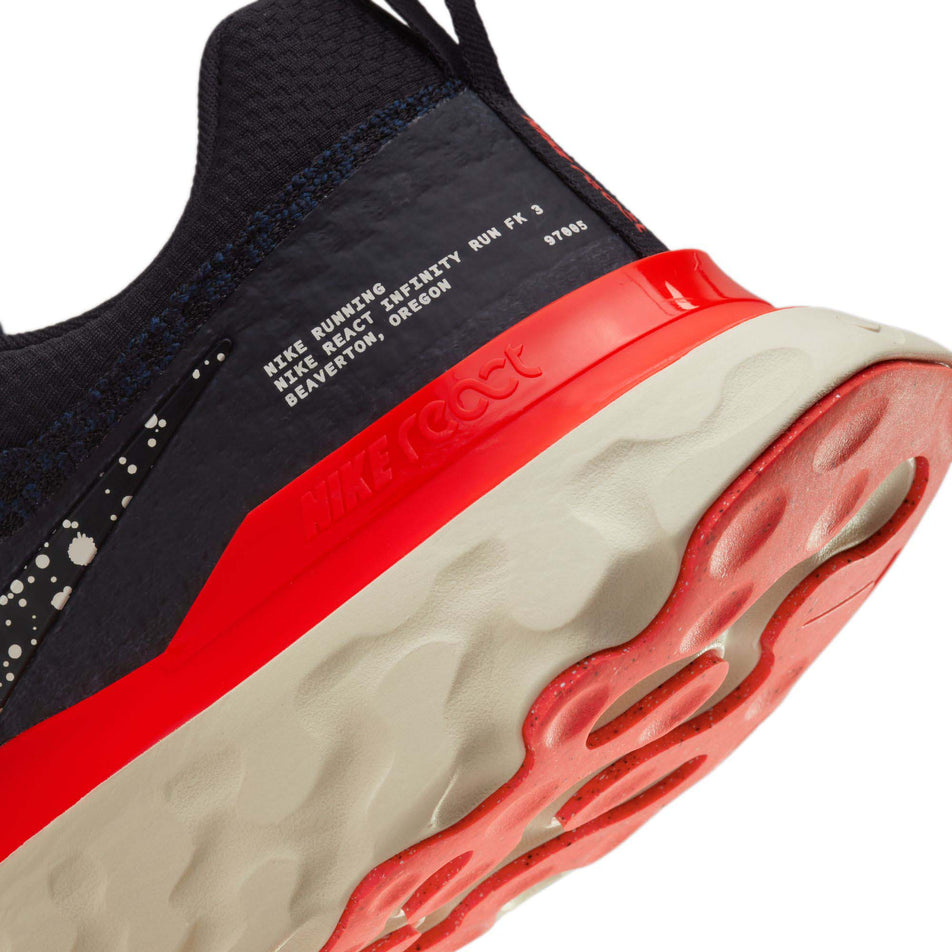 The lateral side of the heel counter on the left shoe from a pair of Nike Men's React Infinity 3 Road Running Shoes (7864285560994)