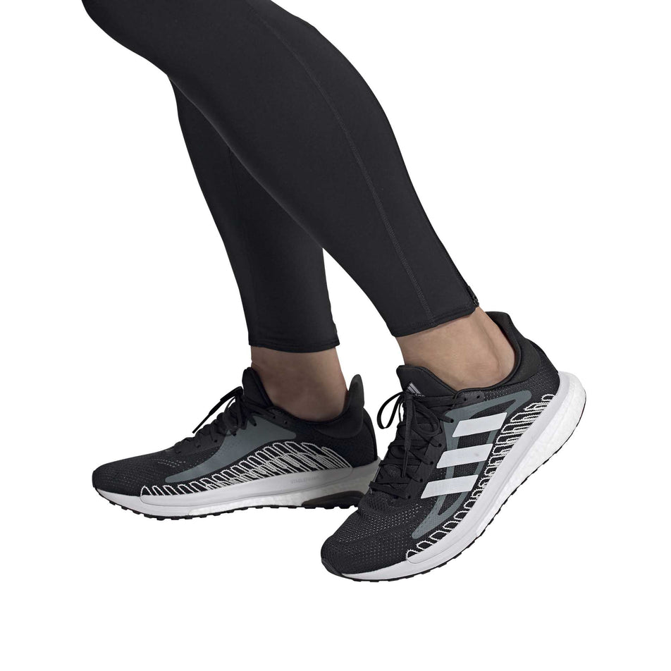 A model wearing a pair of men's adidas Solar Glide ST 3 (6893451608226)