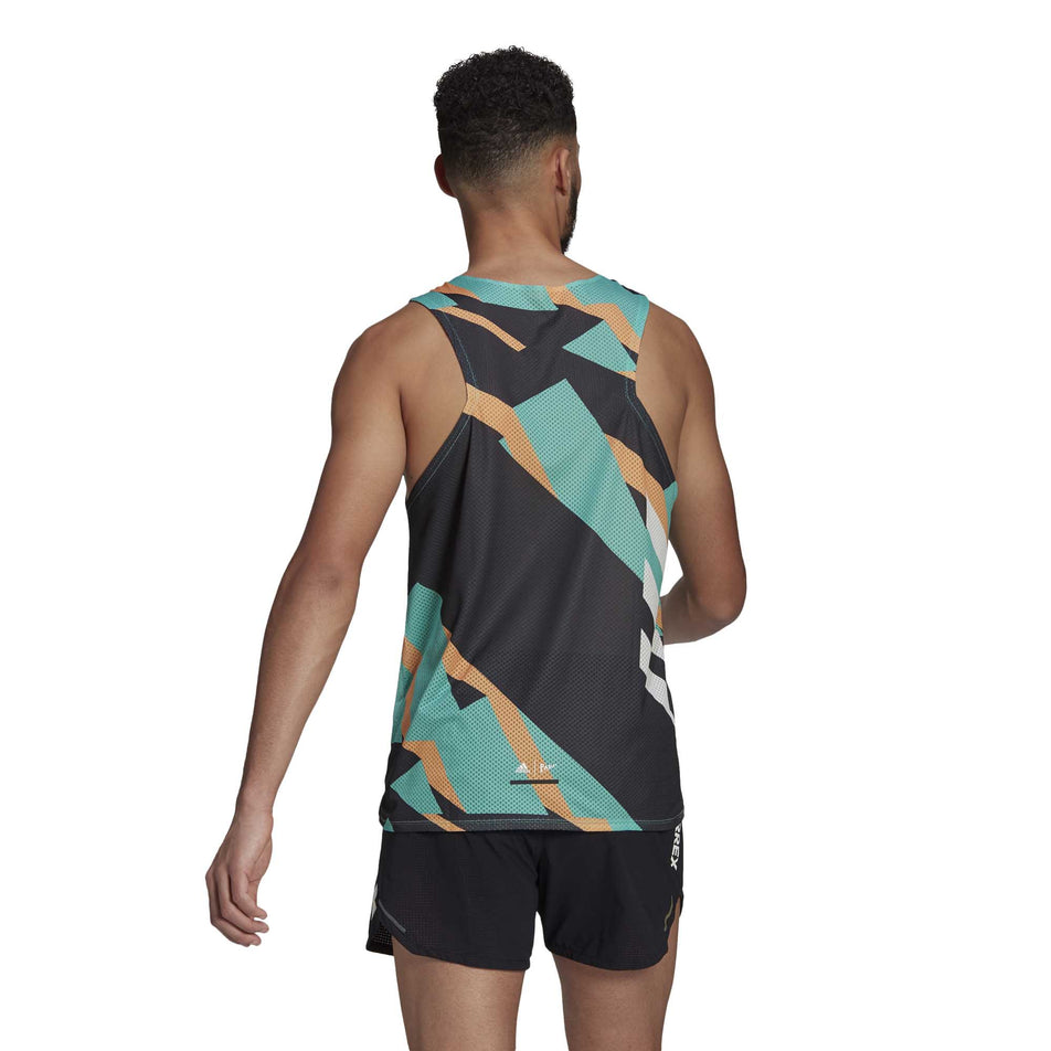 The back of a male model wearing  a men's adidas TERREX AGR Singlet GFX and shorts (6929419272354)
