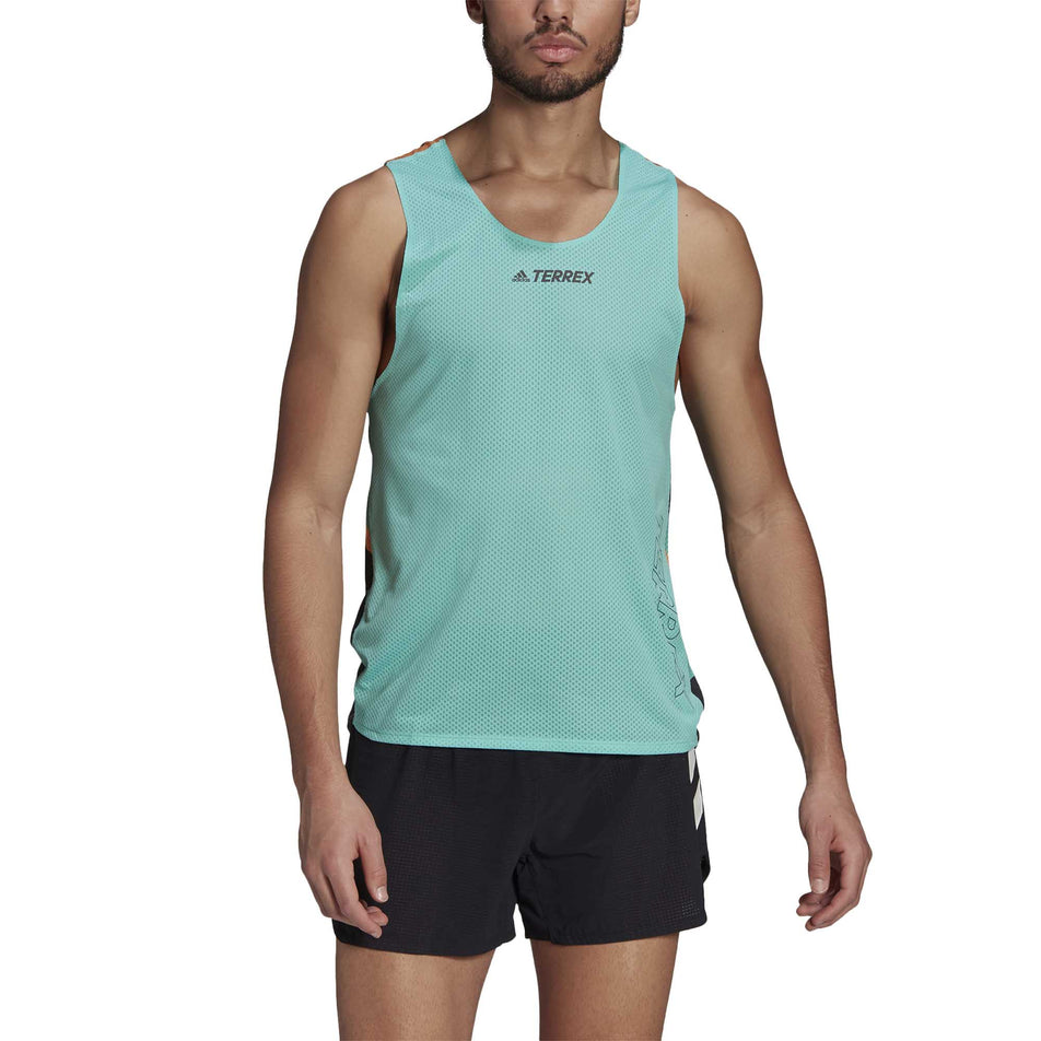 The front of a male model wearing a men's adidas TERREX AGR Singlet GFX and shorts (6929419272354)