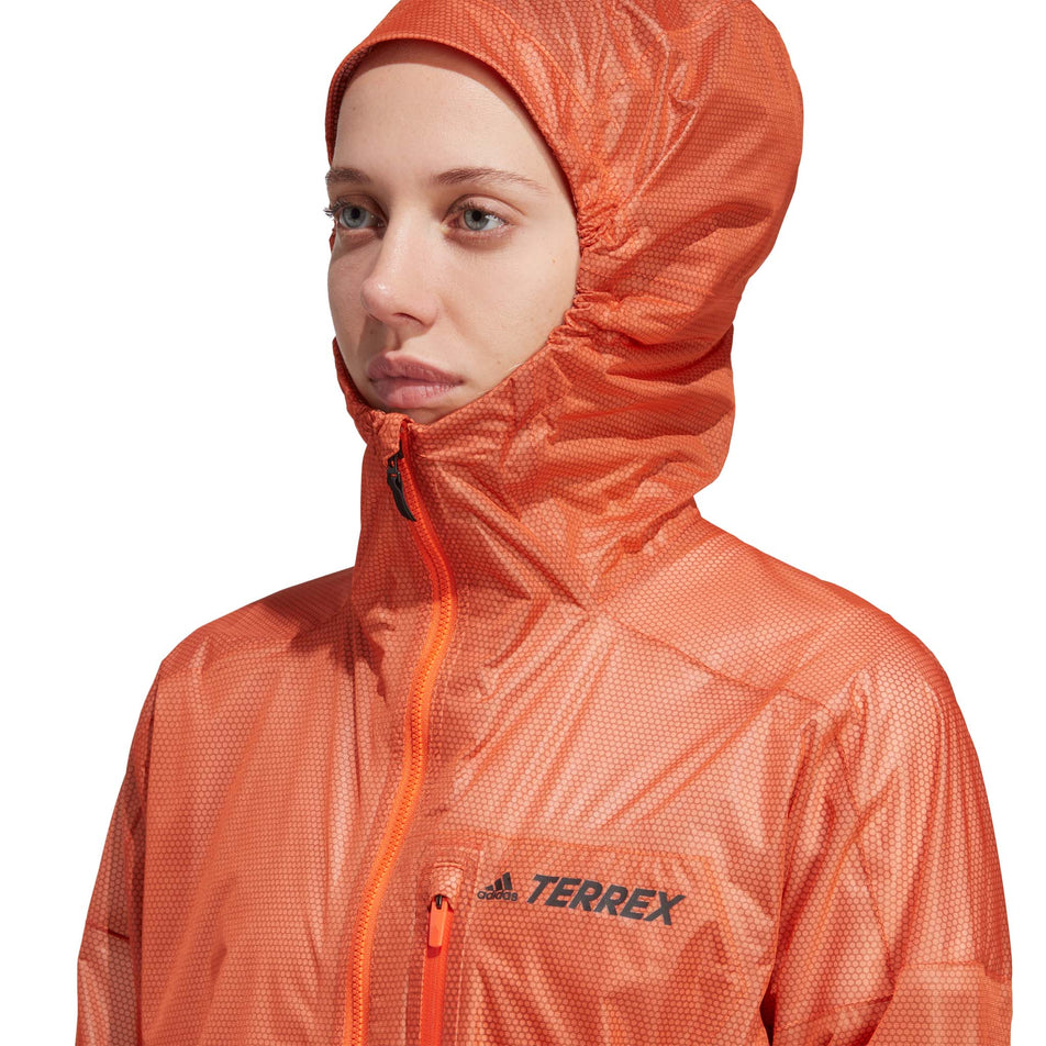 Close-up front view of a model wearing an adidas Women's Terrex Agravic 2.5L Rain.RDY Jacket with the hood up (7766901063842)