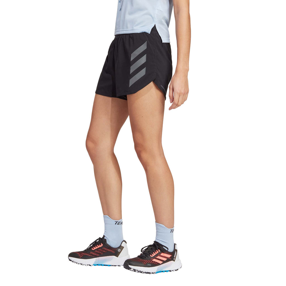 Side view of a model wearing a pair of adidas Women's Agravic Shorts (7766876782754)