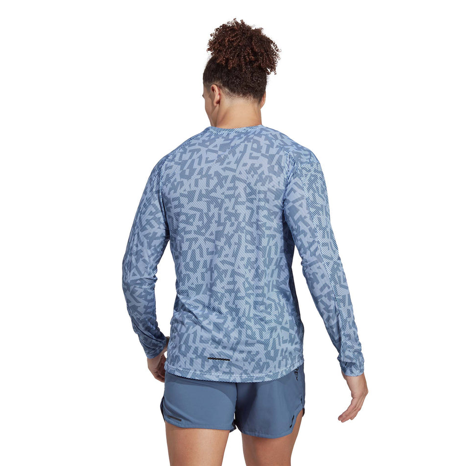 Back view of a model wearing an adidas Men's Terrex Primeblue Trail Graphic Longsleeve (7766877962402)