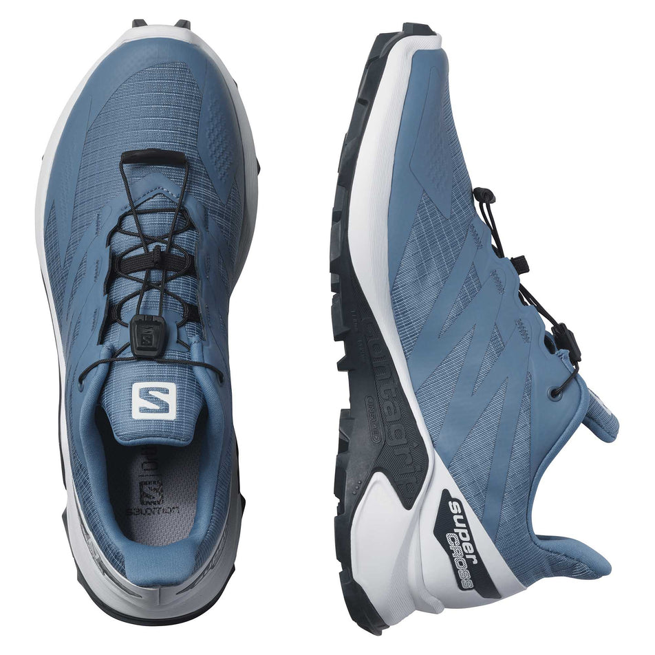 The medial side of the right shoe and the full upper and lace area on the left shoe from a pair of women's Salomon Supercross Blast (6899902644386)