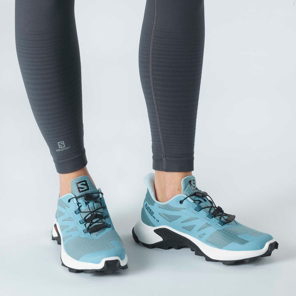 Woman wearing a pair of Salomon Supercross 3 running shoes (6888701198498)