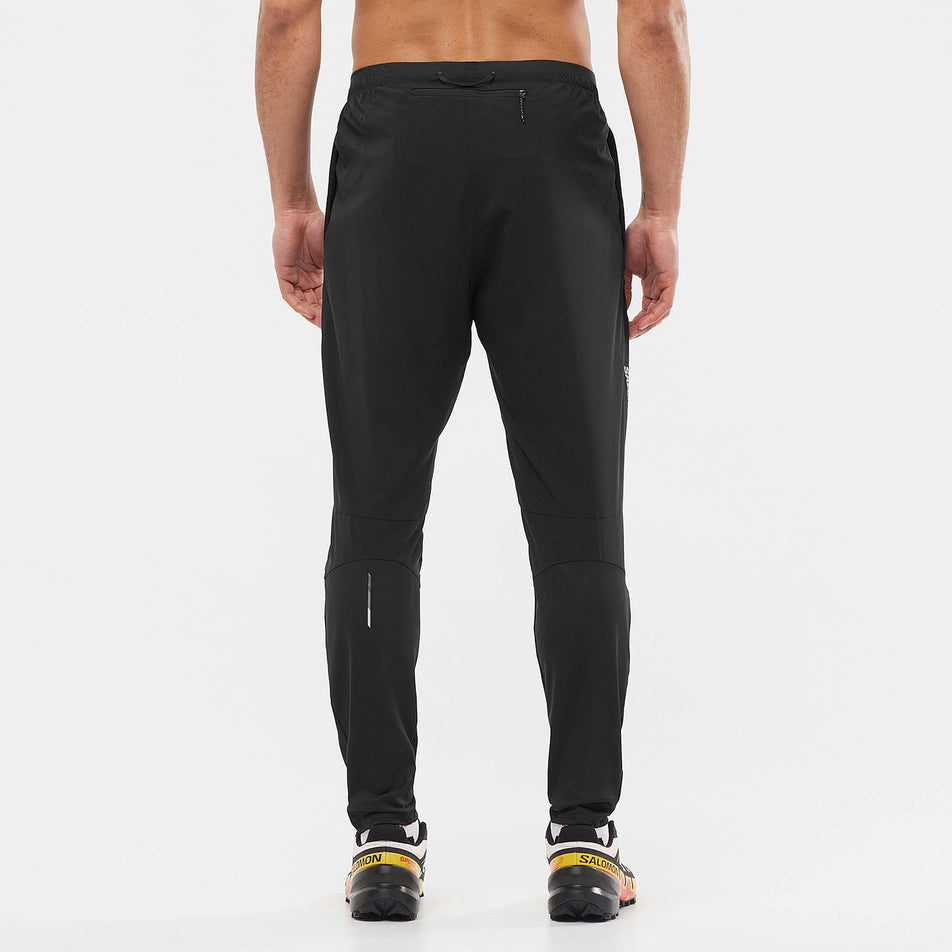 Rear view of Salomon Unisex Cross Run Pant in black. (7766875537570)