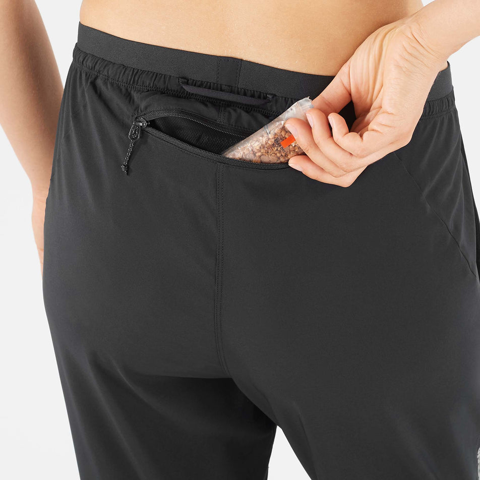 Rear zip pocket view of Salomon Unisex Cross Run Pant in black. (7766875537570)