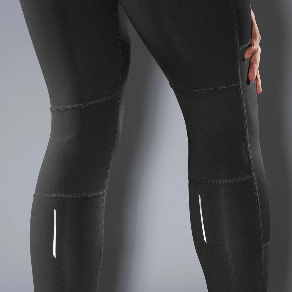 Close-up of reflective strips on the upper calf sections of a pair of Salomon Men's Cross Run Tights (7566049345698)