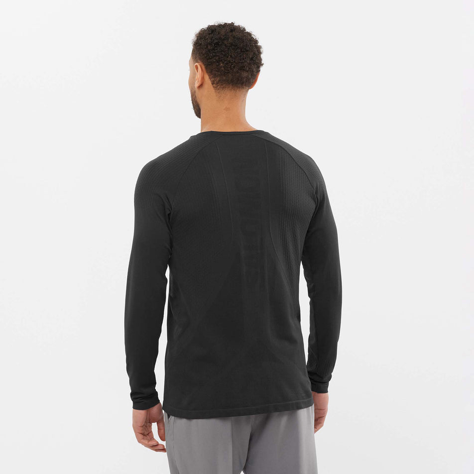 Back view of a model wearing a men's Salomon Sense Aero Long Sleeve T-Shirt (7766862168226)
