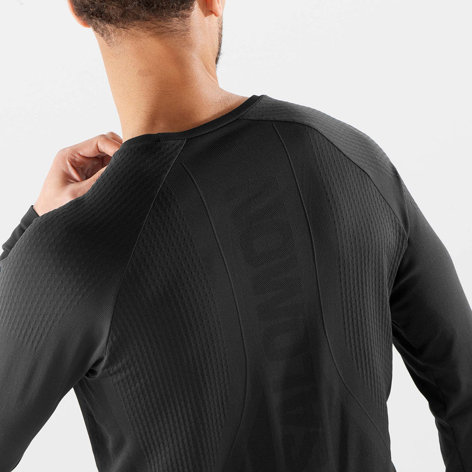 Close-up back view of a model wearing a men's Salomon Sense Aero Long Sleeve T-Shirt (7766862168226)