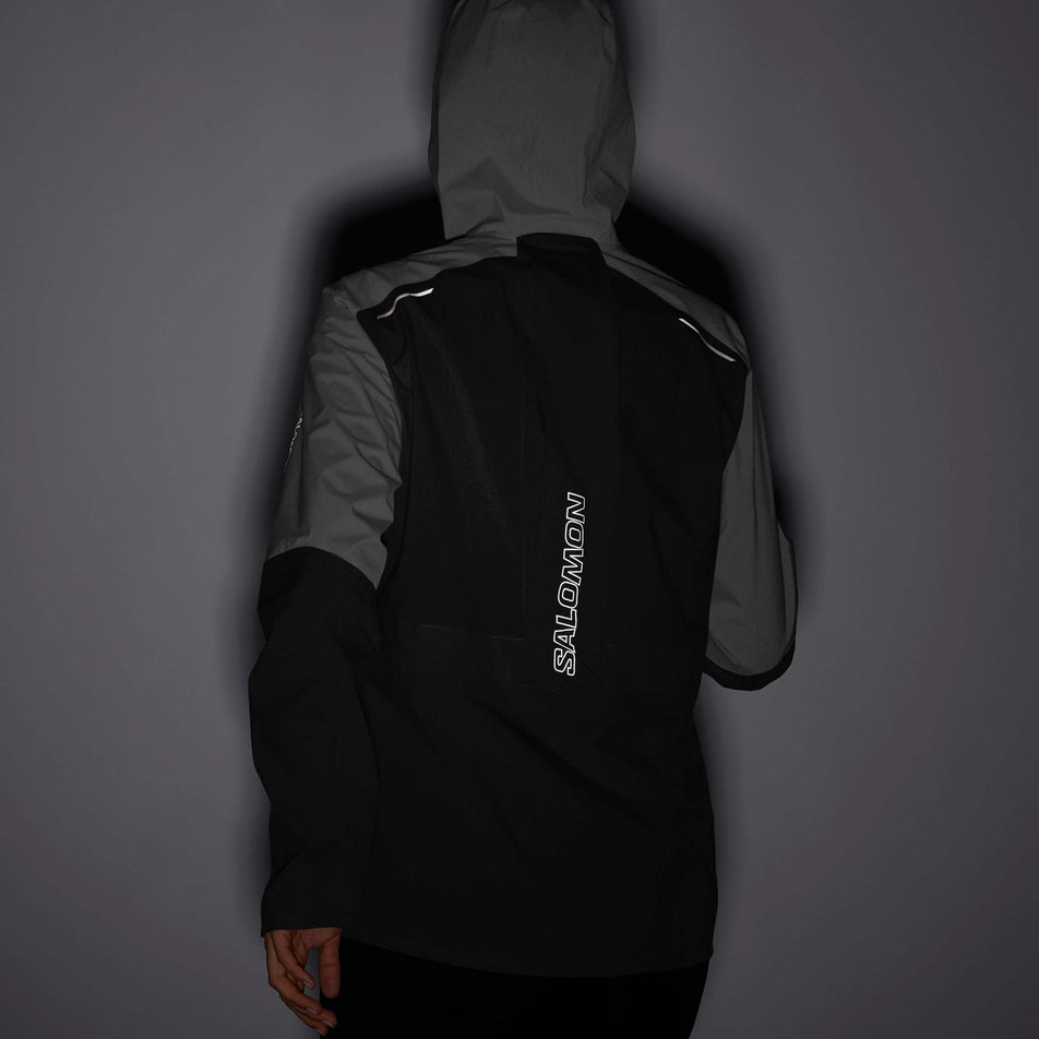 Reflective view of women's salomon bonatti trail jkt in black (7564379422882)