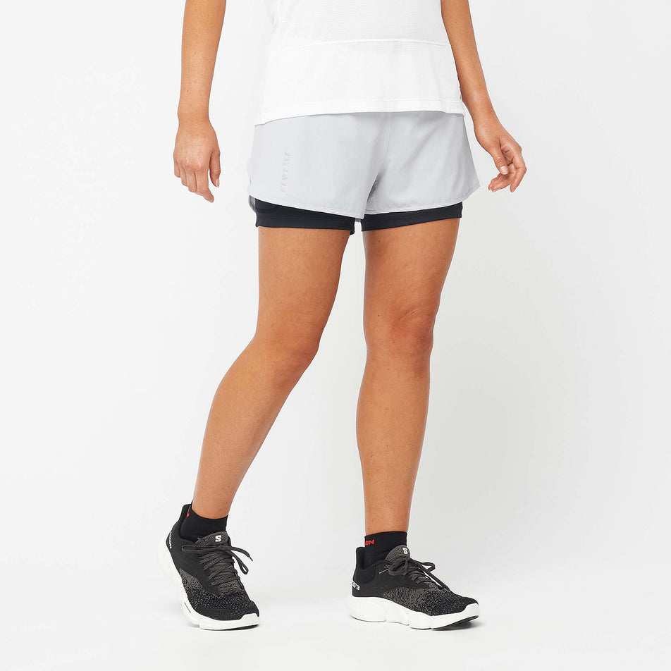 Front view of a model wearing a pair of Salomon Women's Cross 2in1 Shorts in the Oyster Mushroom colourway (7892130201762)