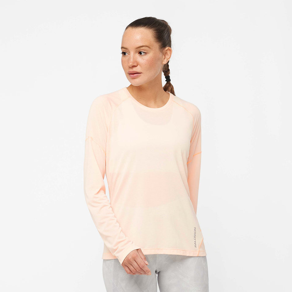 Front view of a model wearing a Salomon Women's Cross Run Long Sleeve T-Shirt in the Cream Tan/Heather colourway (7891226296482)