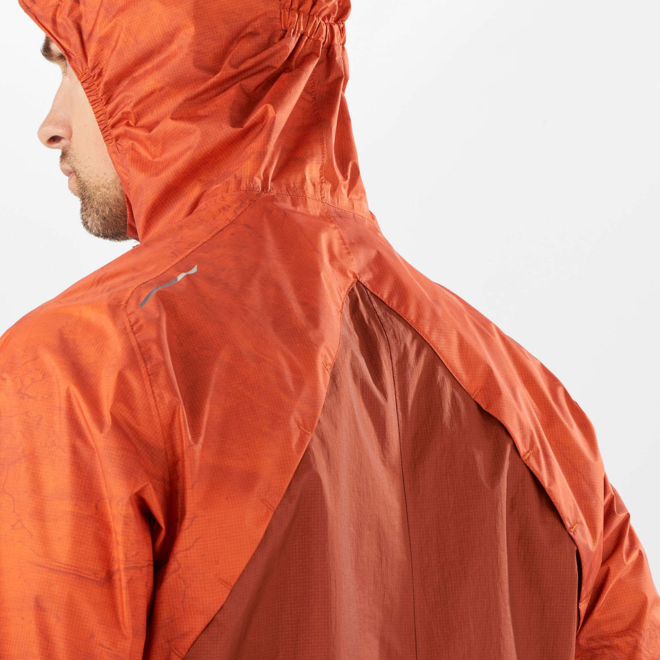Close-up back view of a model wearing a Salomon Men's Bonatti Waterproof Jacket, with the hood up (7885529645218)