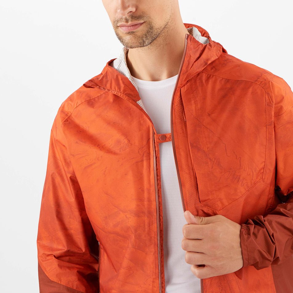 Close-up front view of a model wearing a Salomon Men's Bonatti Waterproof Jacket, with jacket unzipped (7885529645218)