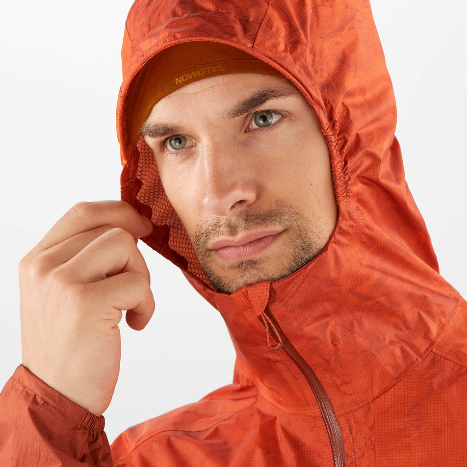 Close-up front view of a model wearing a Salomon Men's Bonatti Waterproof Jacket, with the hood up (7885529645218)