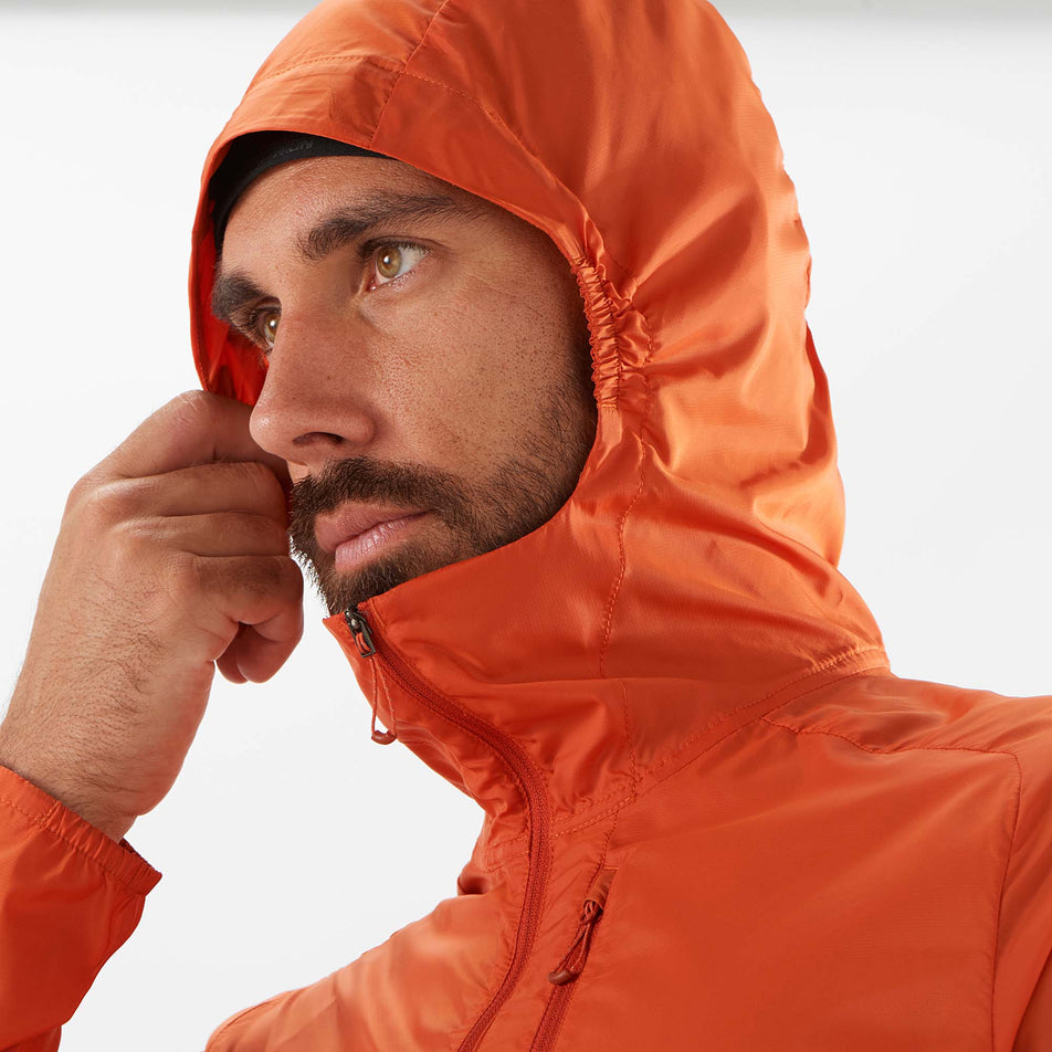 Close-up front view of a model wearing a Salomon Men's Bonatti Cross Wind Jacket Hoodie - with the hood up (7889270866082)