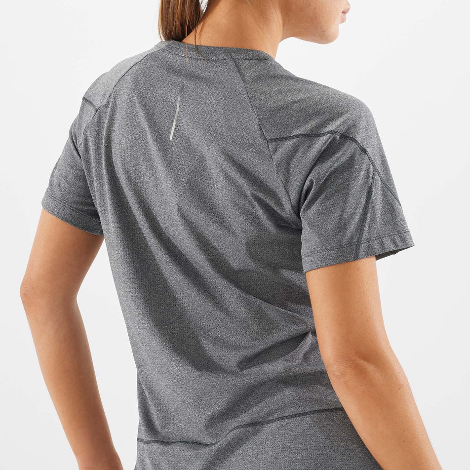 Close-up back view of a model wearing a Salomon Women's Cross Run Short Sleeve T-Shirt in the Deep Black/Heather colourway  (7891233800354)