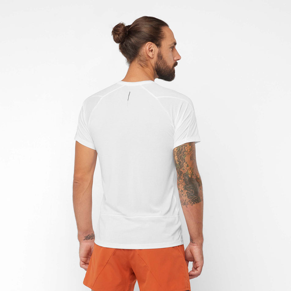 Back view of a model wearing a Salomon Men's Cross Run Short Sleeve T-Shirt - in the White colourway (7889303797922)