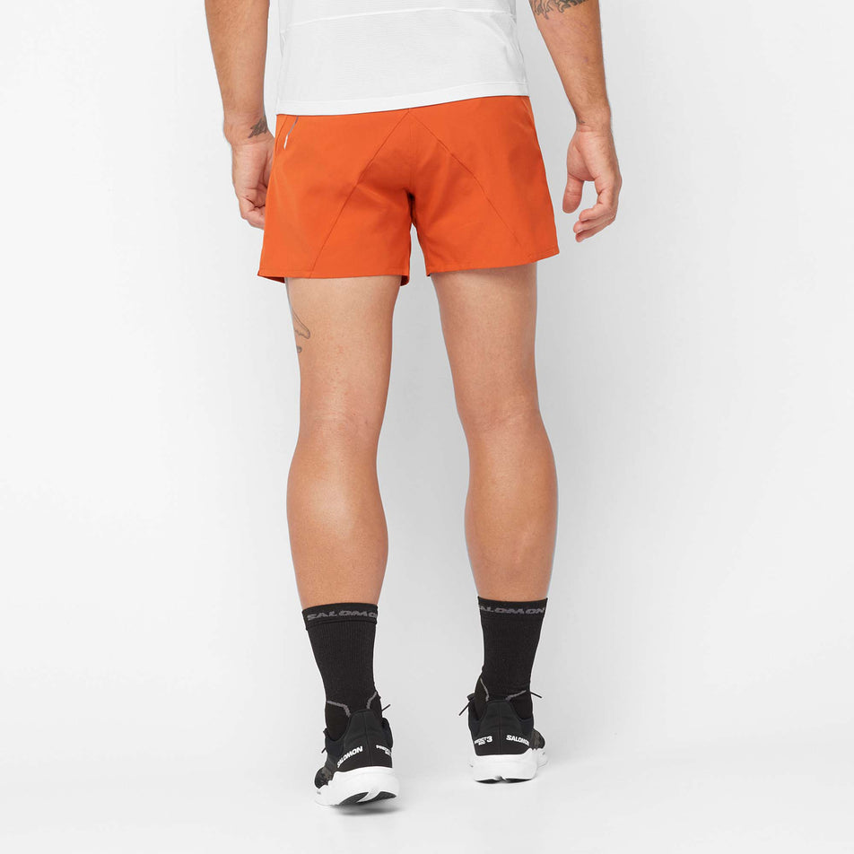 Back view of a model wearing a pair of Salomon Men's Cross 5'' Shorts, in the Burnt Ochre colourway (7889345773730)