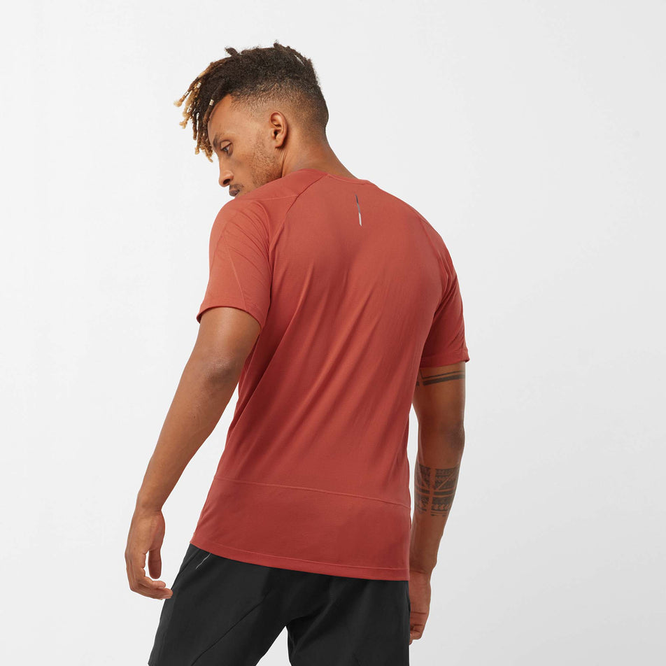 Back view of a model wearing a Salomon Men's Cross Run Short Sleeve T-Shirt - in the Hot Sauce colourway (7889329488034)