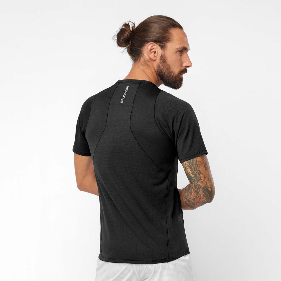 Back view of a model wearing a Salomon Men's Sense Aero Short Sleeve T-Shirt in the Deep Black colourway (7890837635234)