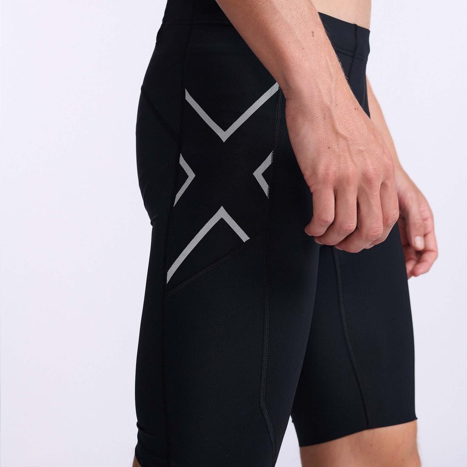 Close-up view of the lateral right side of a pair of 2XU Men's Aero Compression Shorts, being worn by a model (7778319859874)