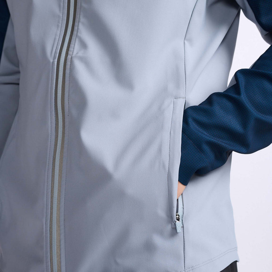 Close-up front view of the lower body section of a 2XU Men's Aero Jacket, being worn by a model (7778521153698)