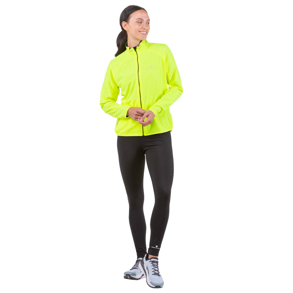 Front view of a model wearing a Ronhill Women's Core Jacket in the Fluo Yellow colourway  (6907662434466)