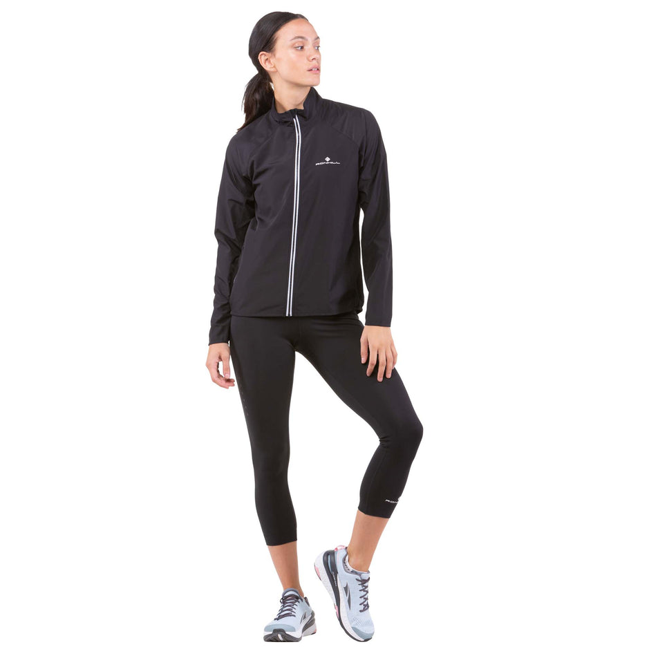 Front view of a model wearing a Ronhill Women's Core Jacket in the All Black colourway (6907646214306)