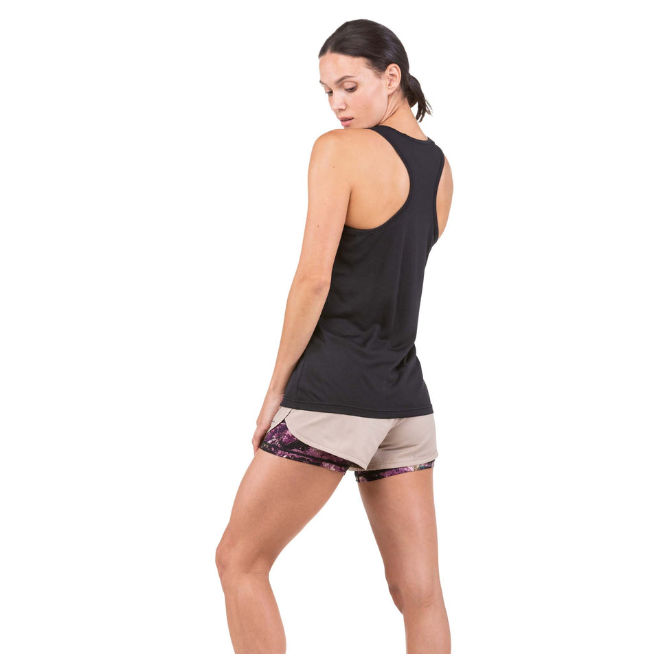 Back view of a model wearing a Ronhill Women's Core Vest in the Black/Bright White colourway (6907713978530)
