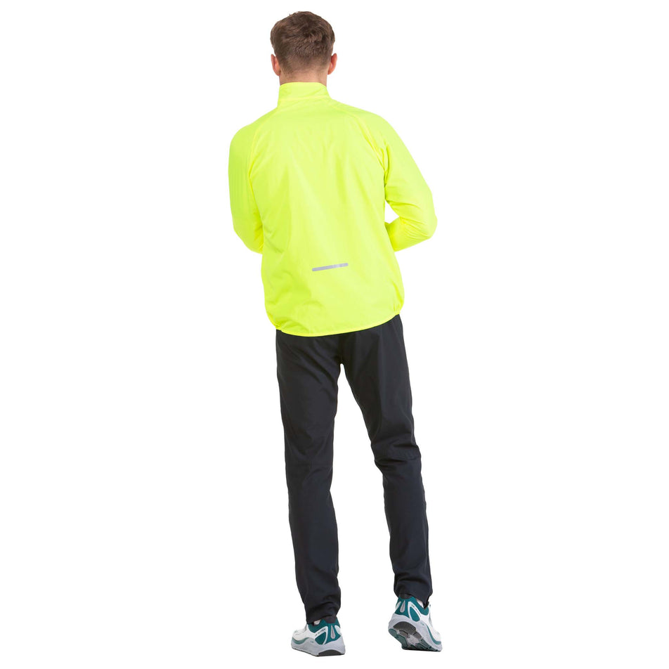 Back view of a model wearing a Ronhill Men's Core Jacket in the Fluo Yellow/Black colourway (6908246425762)