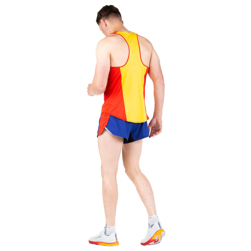 Back view of a model wearing a Ronhill Men's Tech Revive Racer Vest in the Flame/Solar colourway (7743543967906)